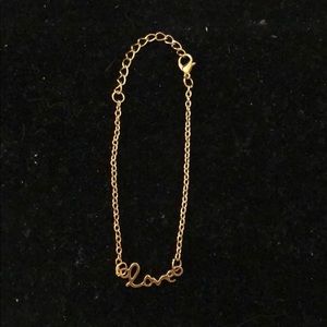 Gold tone bracelet with word “ love”